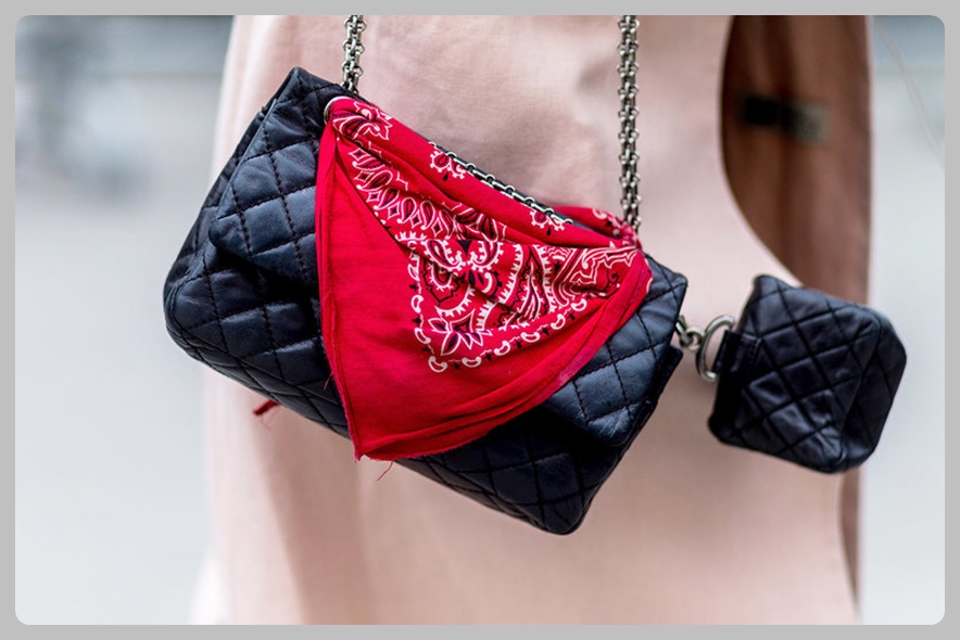PARIS, FRANCE - JULY 05: Black Chanel bags with a red bandana outside Chanel during Paris Fashion Week Haute Couture F/W 2016/2017 on July 5, 2016 in Paris, France. (Photo by Christian Vierig/Getty Images)